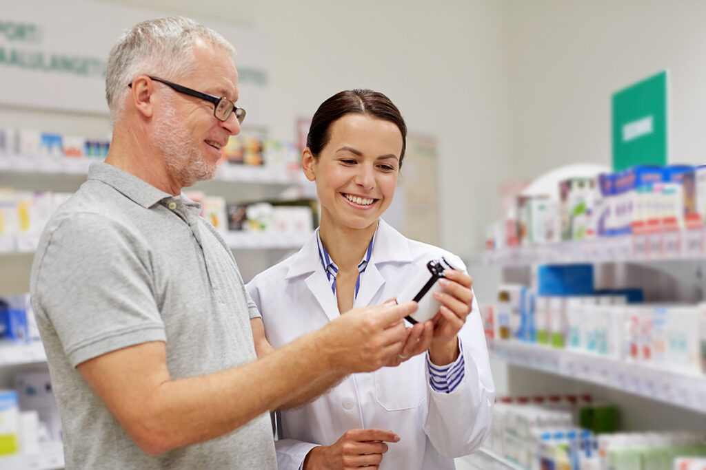 a pharmacist helps a patient with a prescription