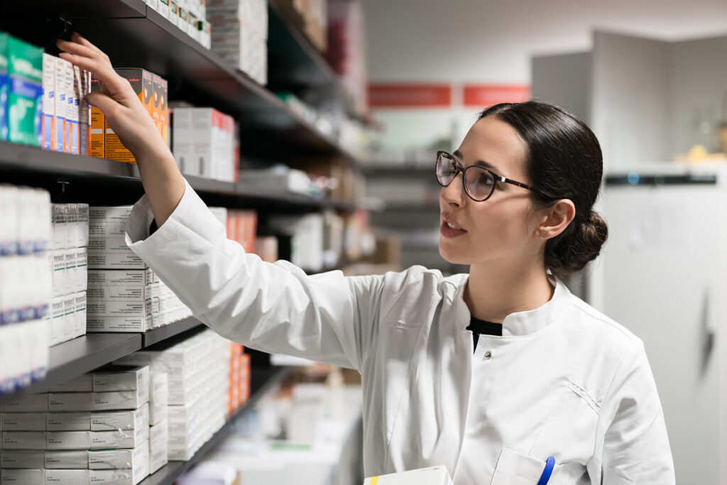a pharmacist helps a patient with a prescription