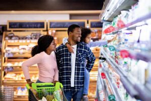 a family shops together at the supermarket