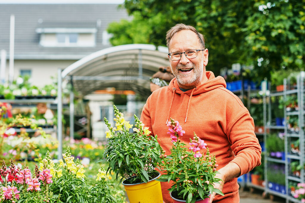 a man shops for plants and flowers at a garden center