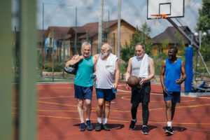 a group of older men play basketball together