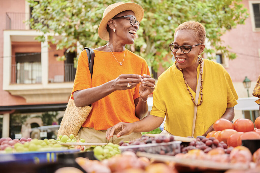 two friends shop at a farmers market