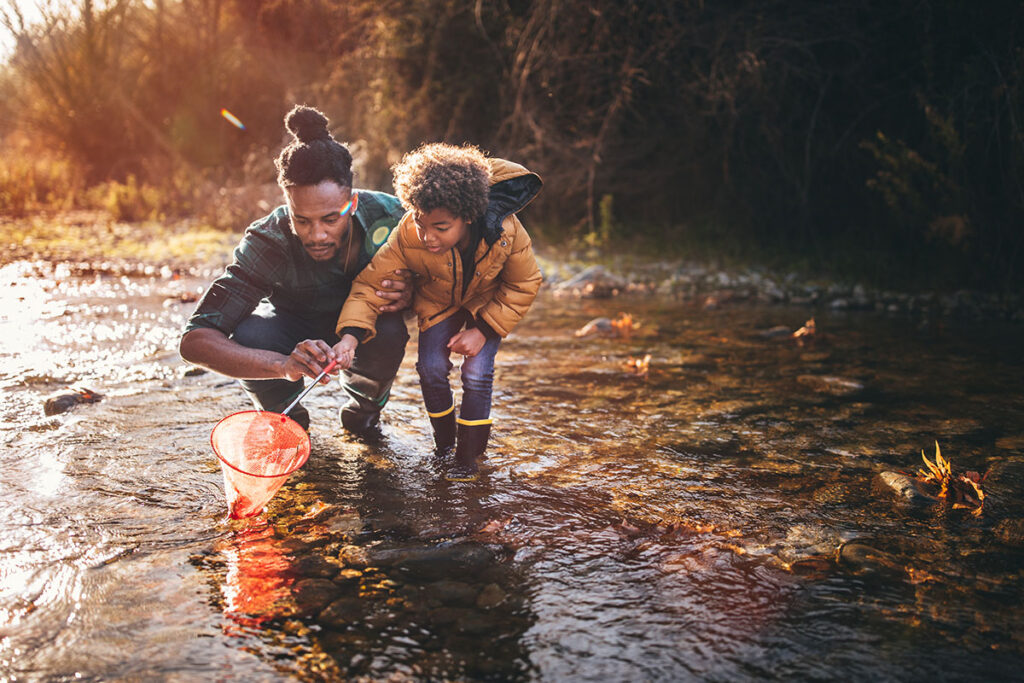 a man and his son explore a river bed