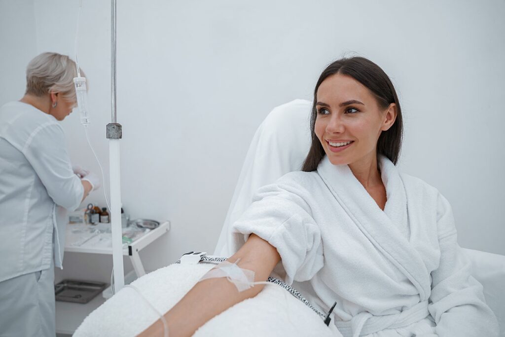 a patient smiles while receiving intravenius medication