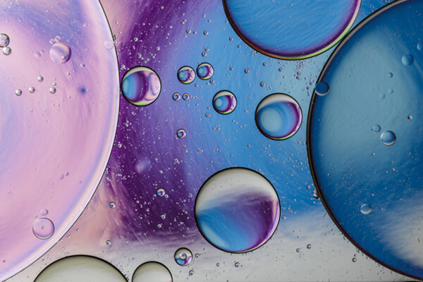 Liquid in a dish with muted colors in the background