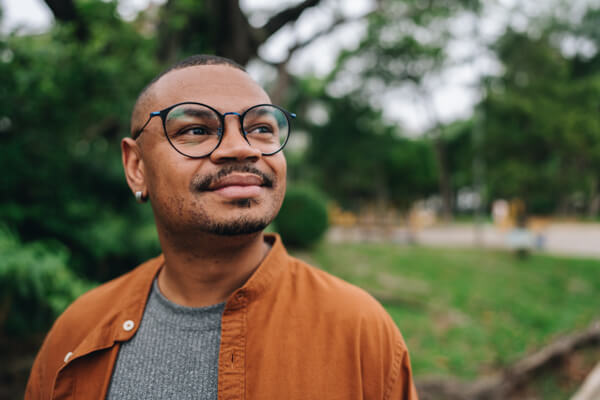 Young man smiling while taking a walk outside