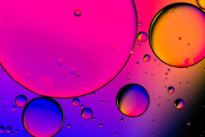 Liquid in a dish with bright colors shining against the dish