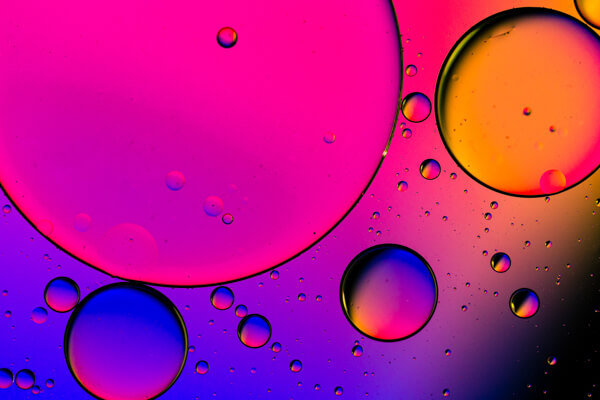 Liquid in a dish with bright colors shining against the dish