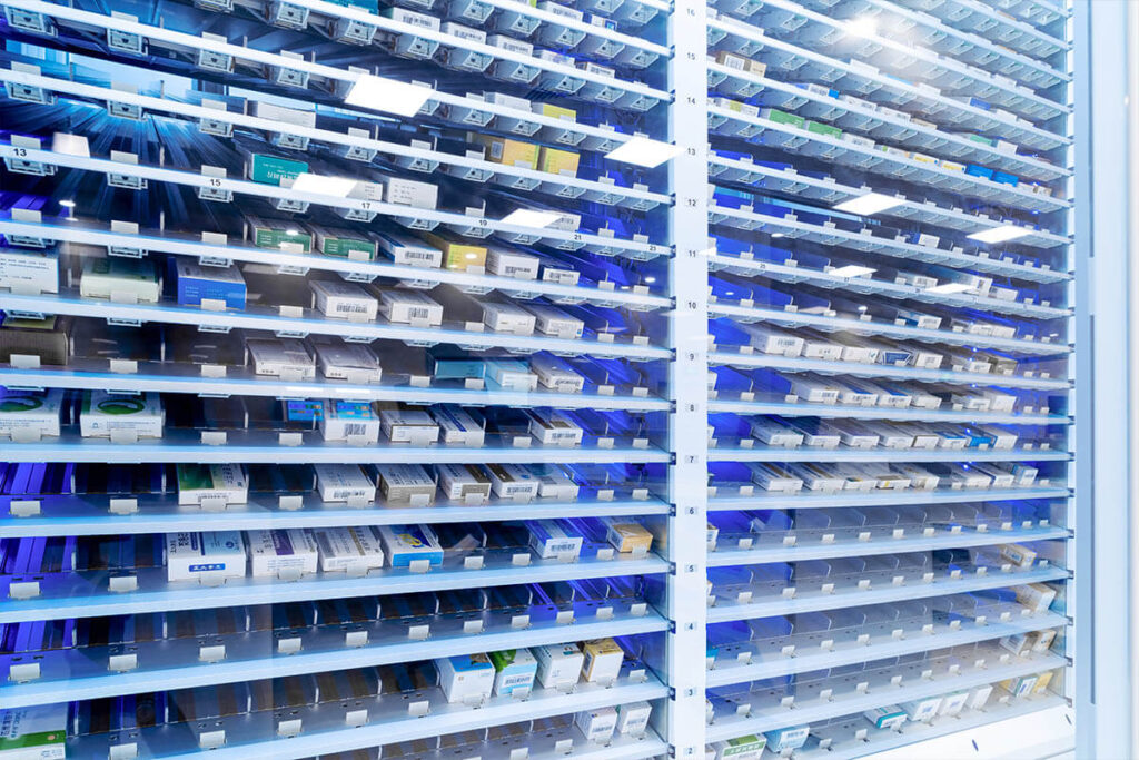 pharmacy shelves filled with small organized medication bins